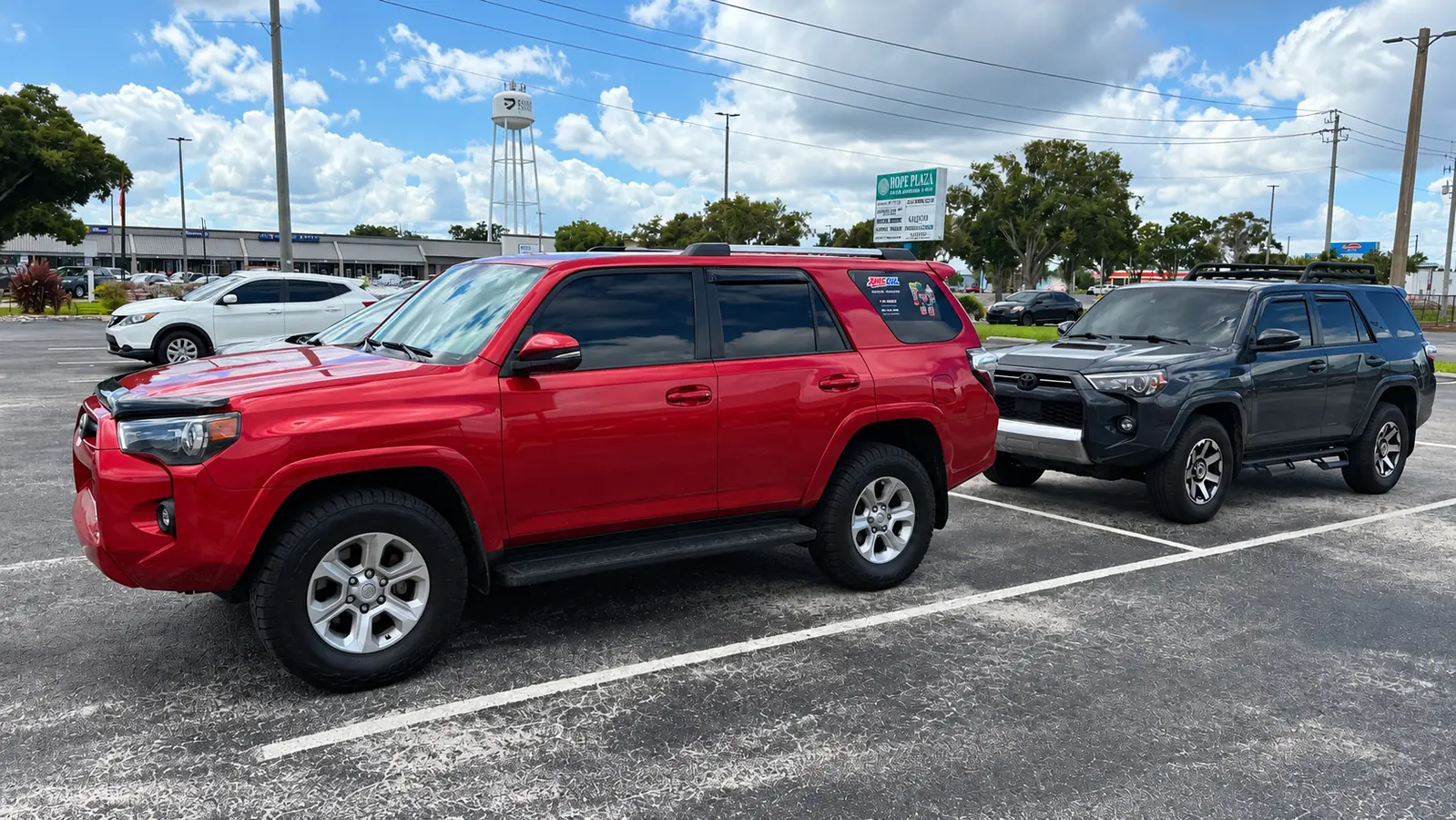 Red Toyota 4Runner with 4.0L 1GR-FE engine parked beside another 4Runner